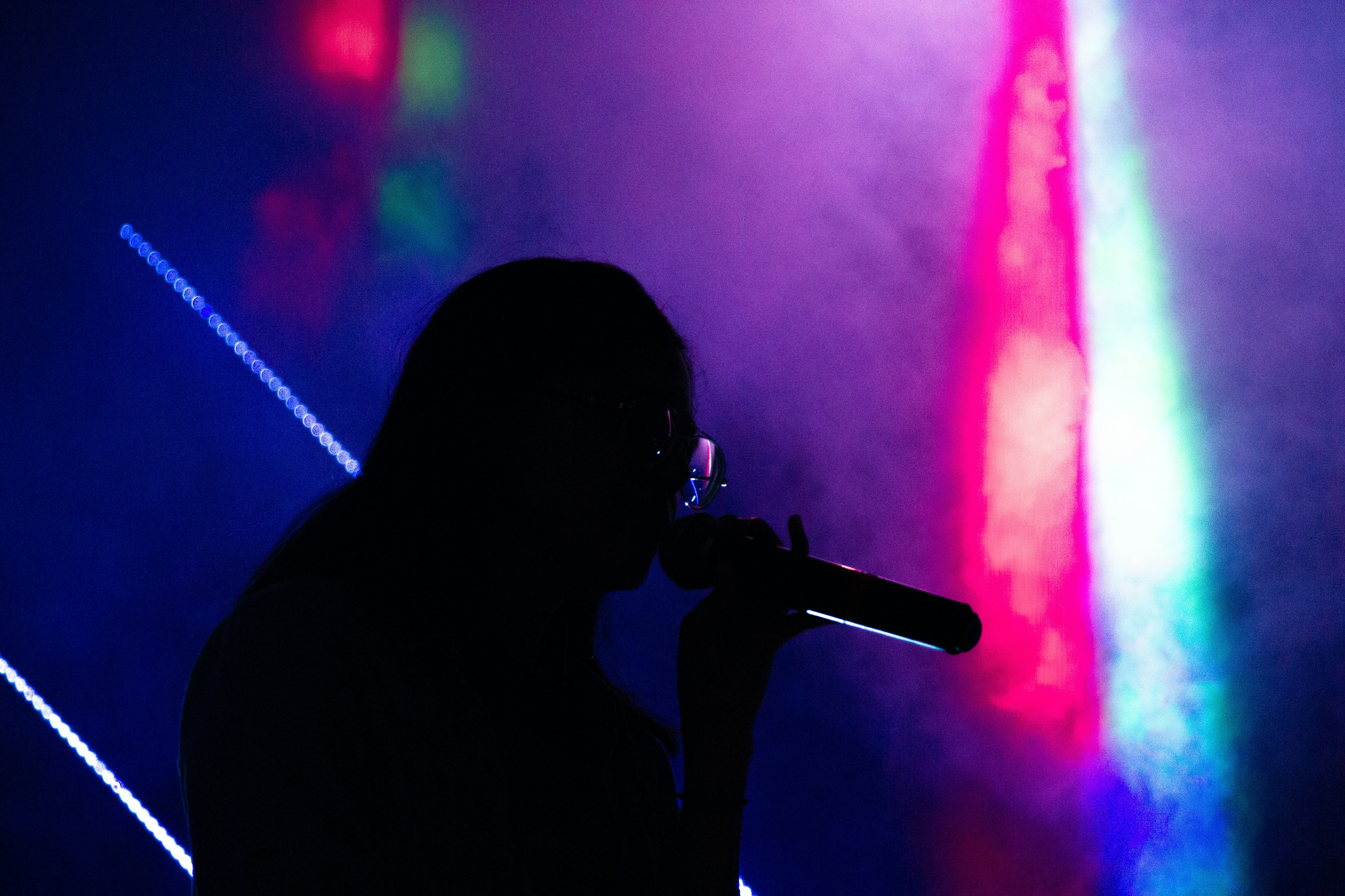 man singing on stage - how to write love songs