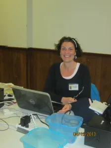 Woman working on a laptop at a crop table