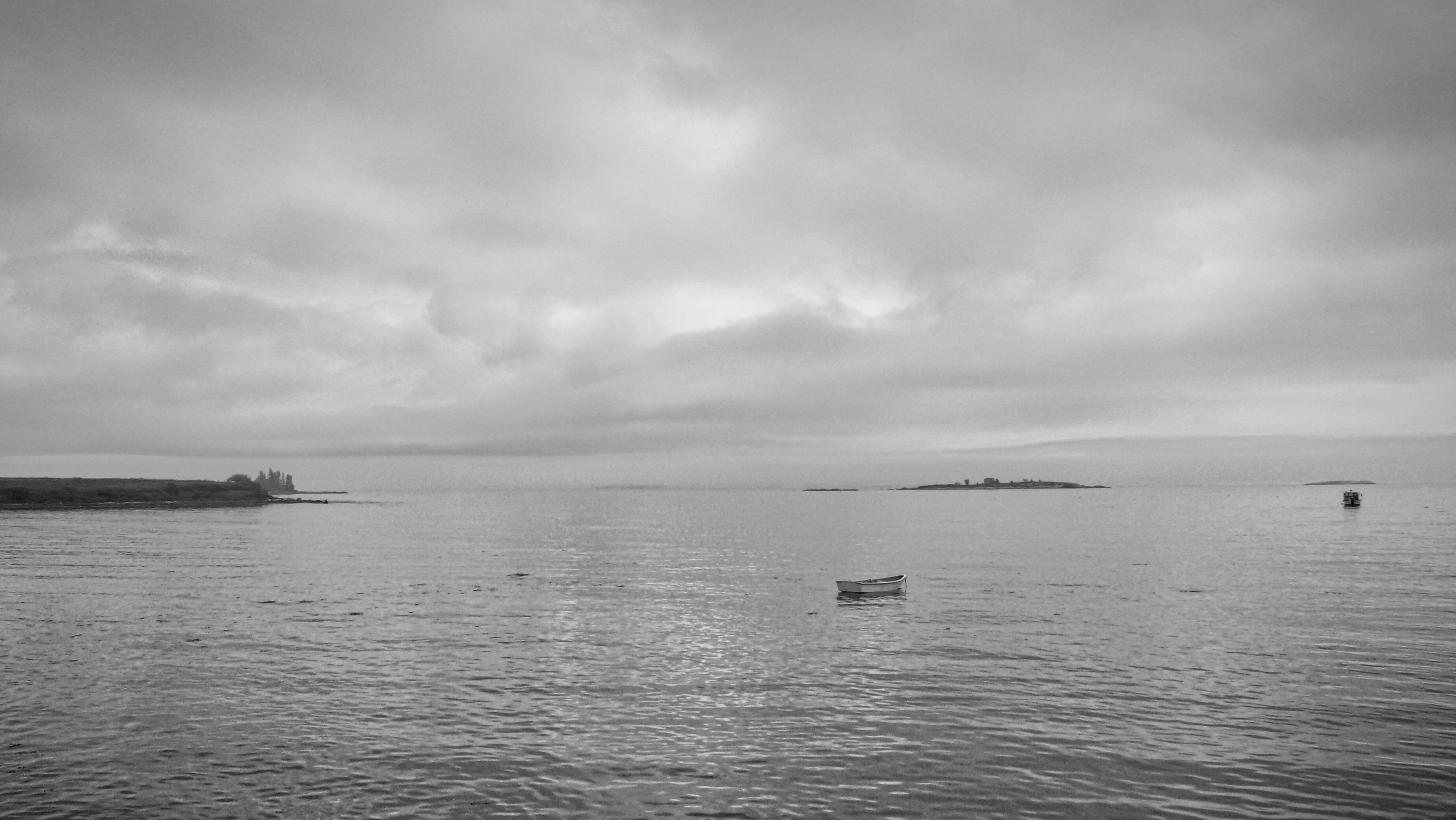 A quiet seascape beneath an overcast sky