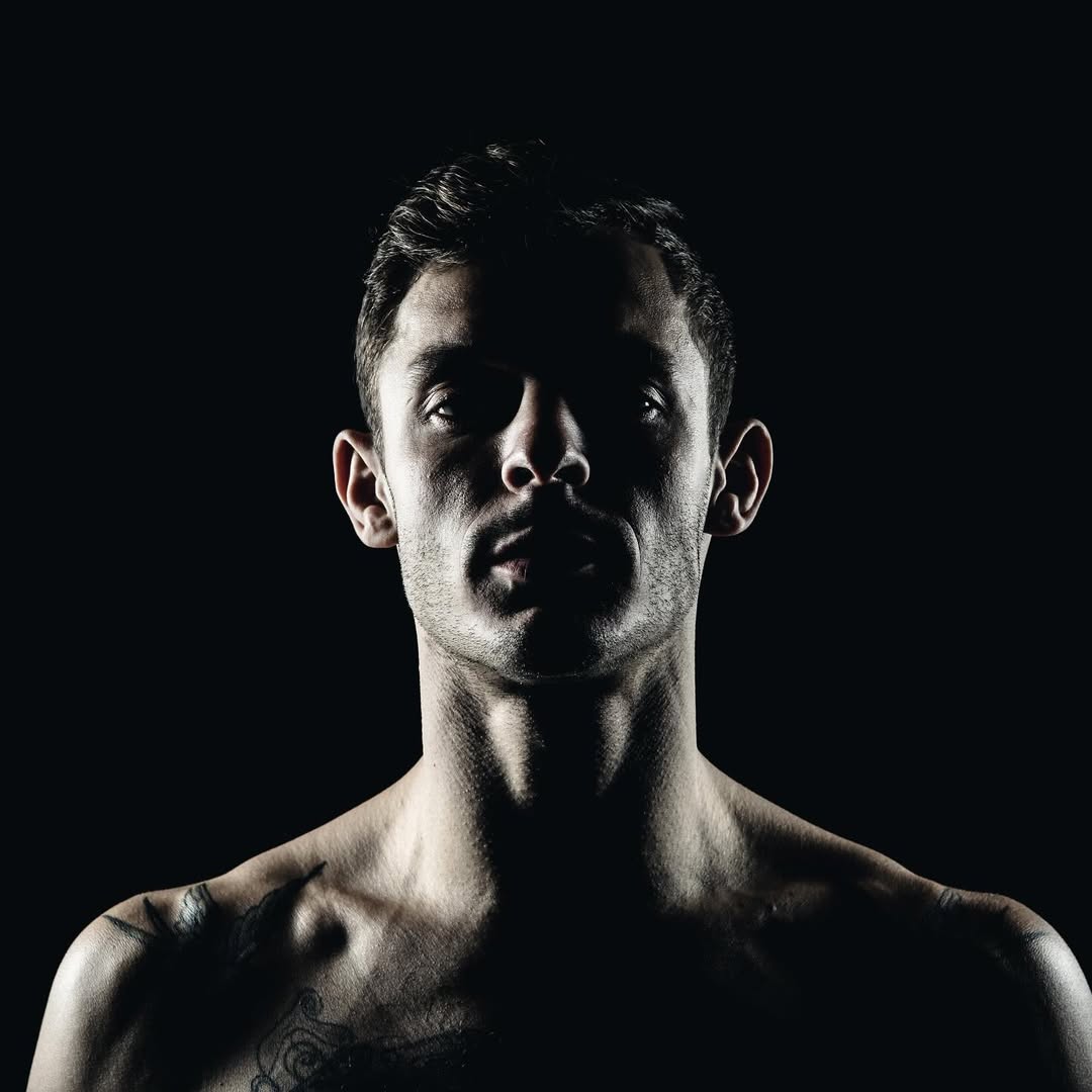 Dramatic portrait of Danilo Dash Creati with strong shadows and studio lighting.