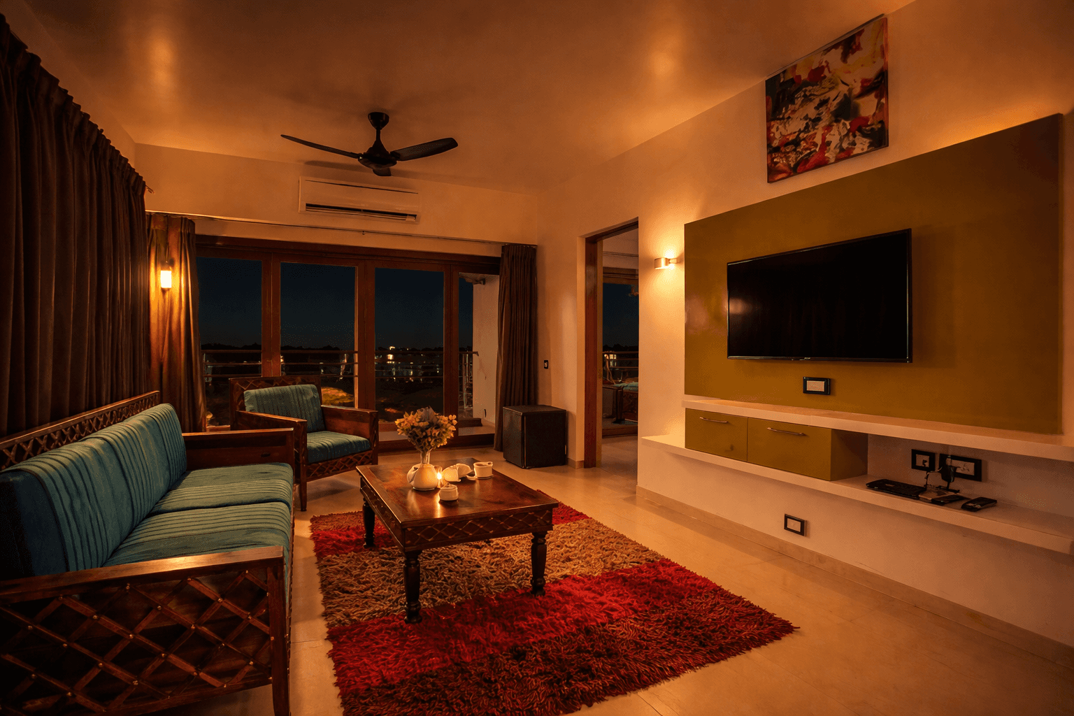 the entire room interior, ocean horizon visible, king bed neatly made, airy curtains flowing in the breeze.