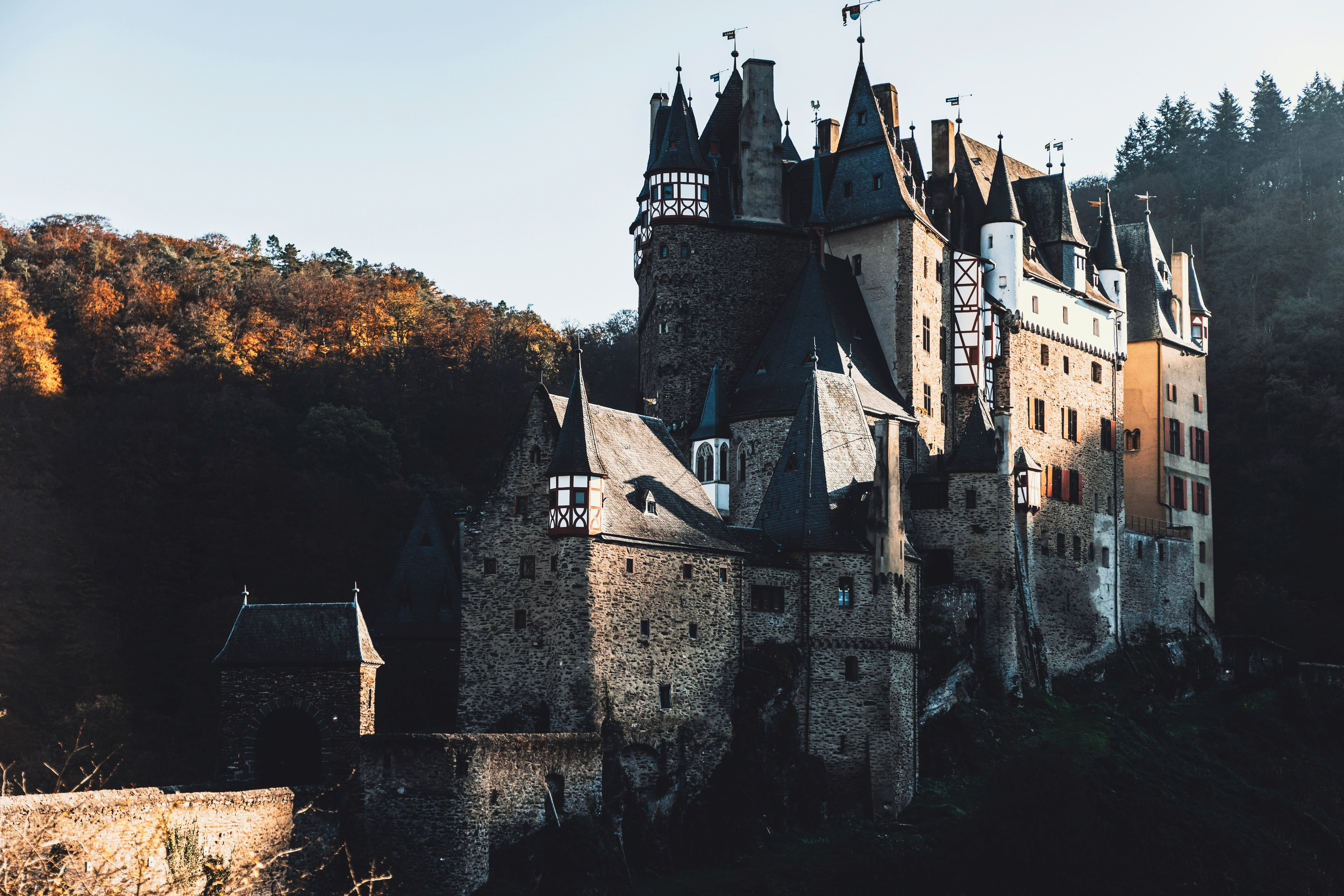 brown wooden folding chairs on green grass field near body of water during daytime
