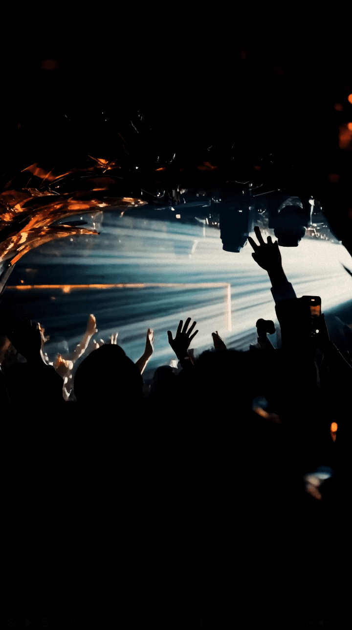 Woman in black outfit sitting on bar stool, leg extended