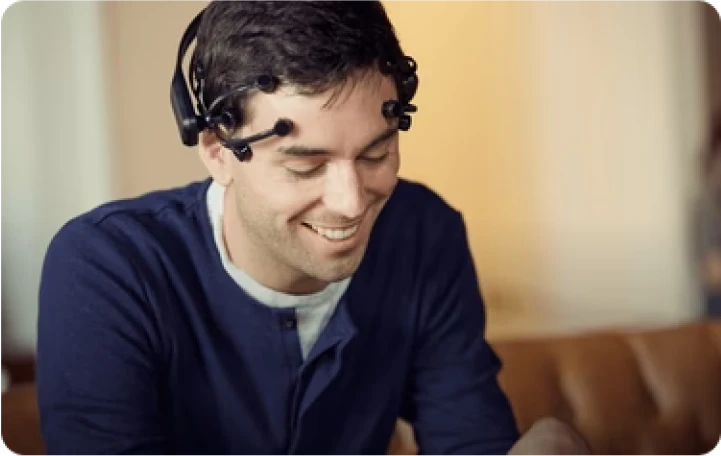 Man wearing Emotiv EEG headset