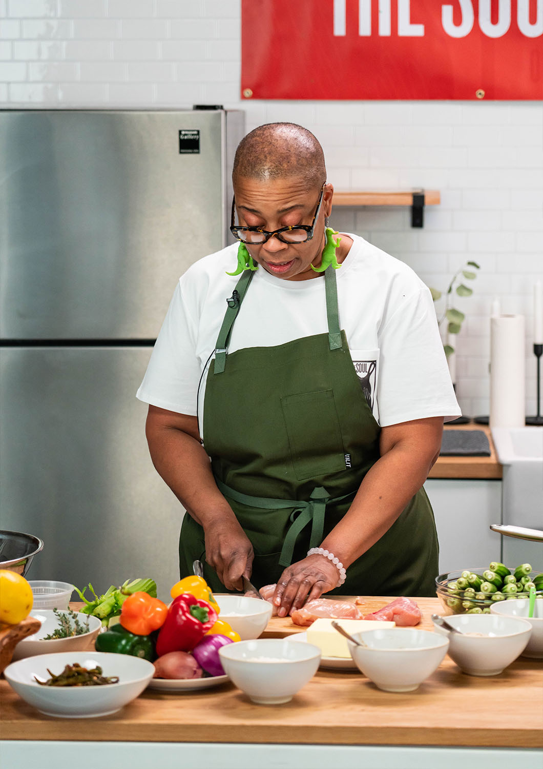Chef Kristi Brown chopping vegetables at the studio kitchen at Particle Studios in Seattle WA.