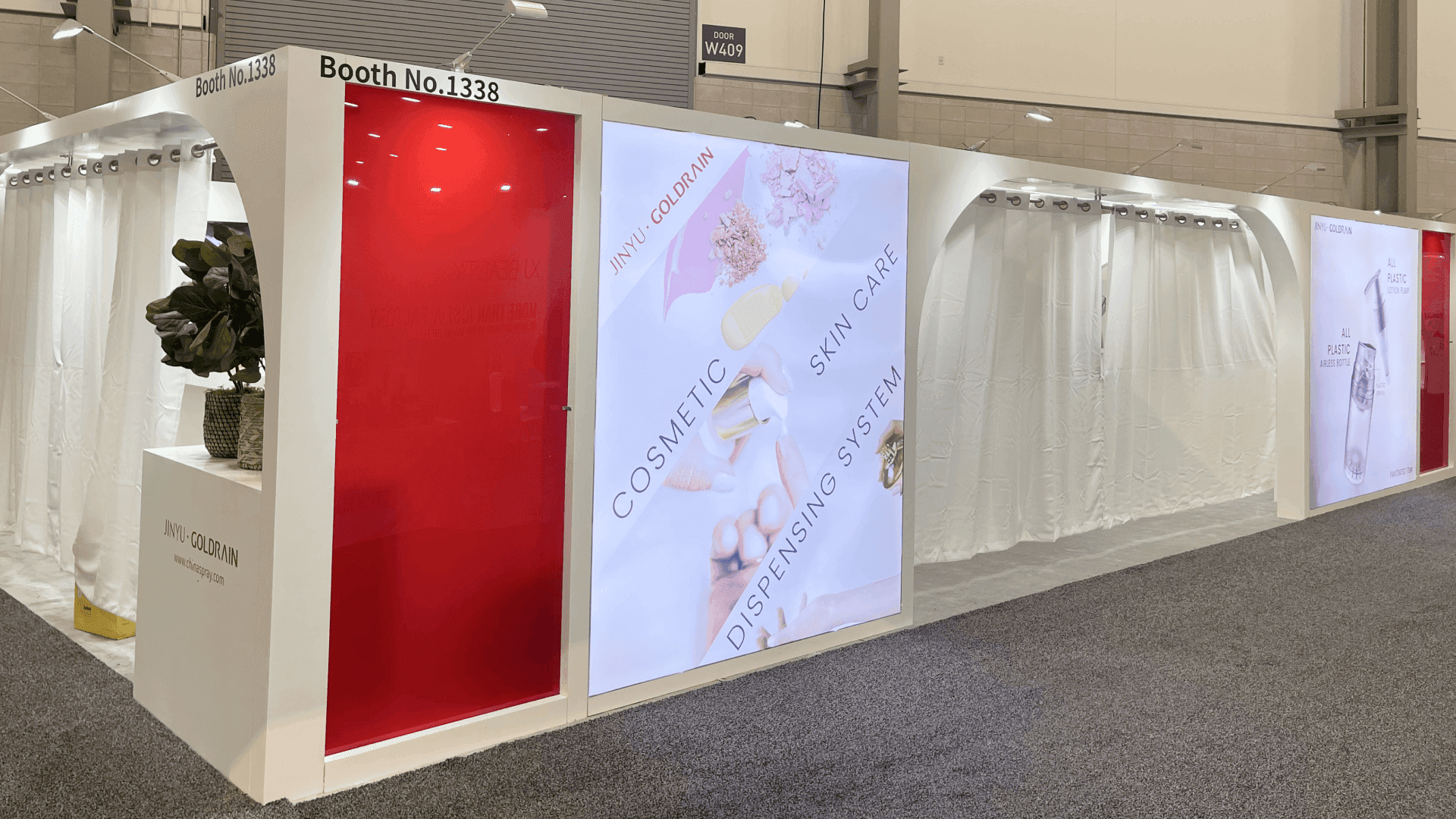 inyu Cosmoprof North America 2023 20x30 retail product display booth exterior with red side wall, backlit cosmetic skincare graphic panel, curtain-front structure, and aisle-facing presentation wall. img4 caption: 20x30 retail product display booth exterior with red side wall, backlit cosmetic skincare graphic panel, curtain-front structure, and aisle-facing presentation wall for Jinyu at Cosmoprof North America 2023.