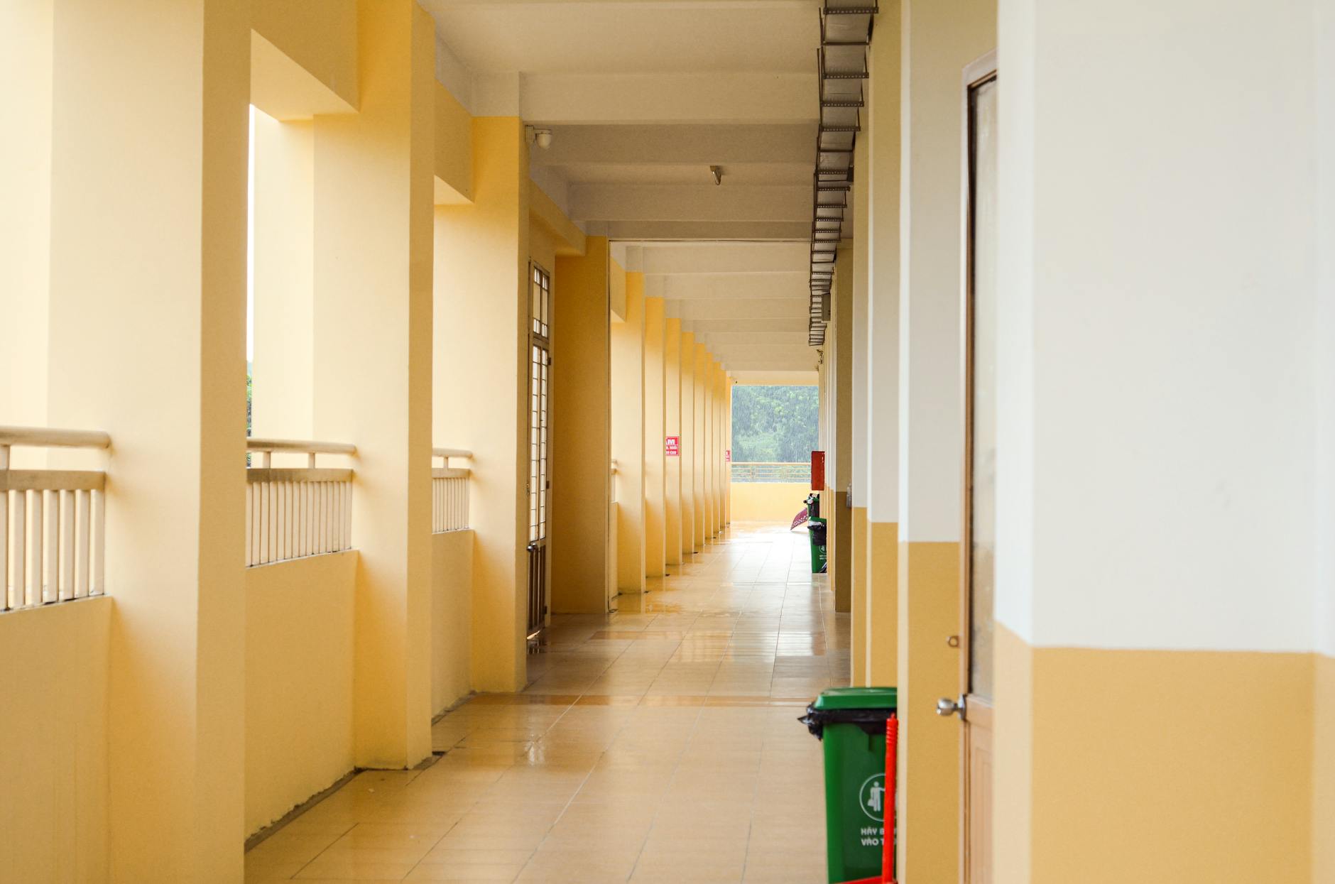 School administrators and teachers sitting around a conference table reviewing printed curriculum guides and maps.