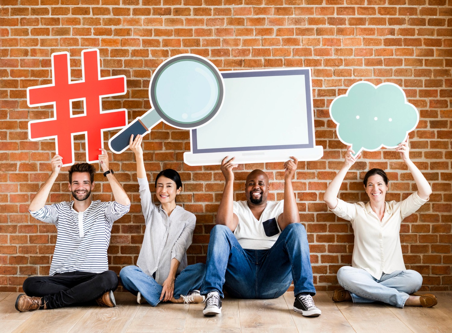 A diverse group of individuals proudly displaying signs featuring various hashtags, promoting unity and social awareness.