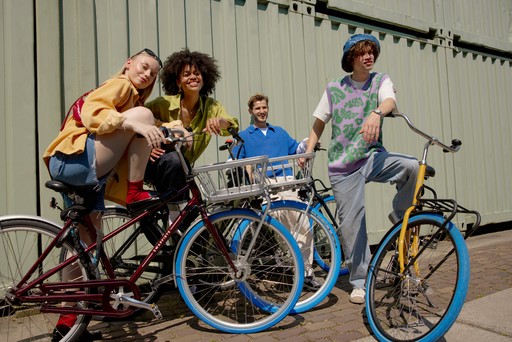 two people walking with bikes