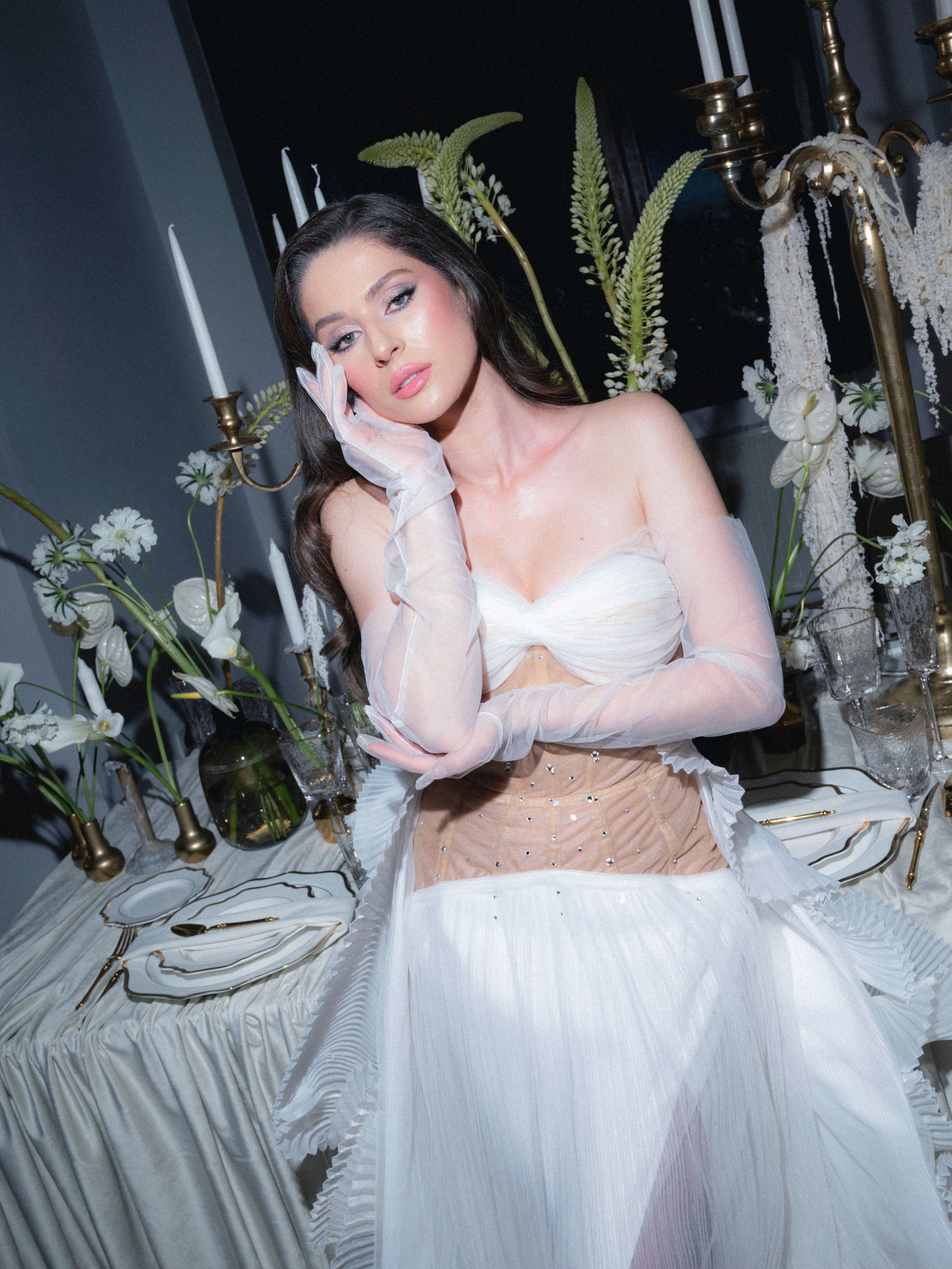 Mireasă elegantă într-un decor floral sofisticat, fotografie bridal editorială cu lumină dramatică și detalii fashion, ședință foto artistică de nuntă realizată de Radu Iordan fotograf de nuntă.