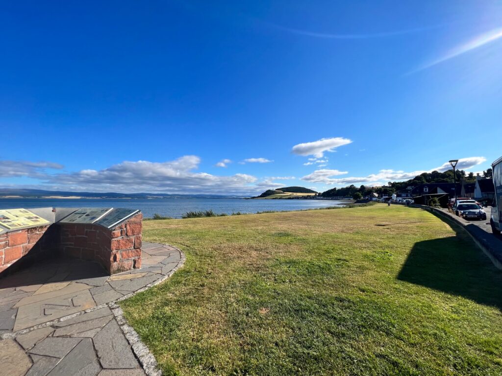 The sea, the blue sky and a row of houses along the sea.