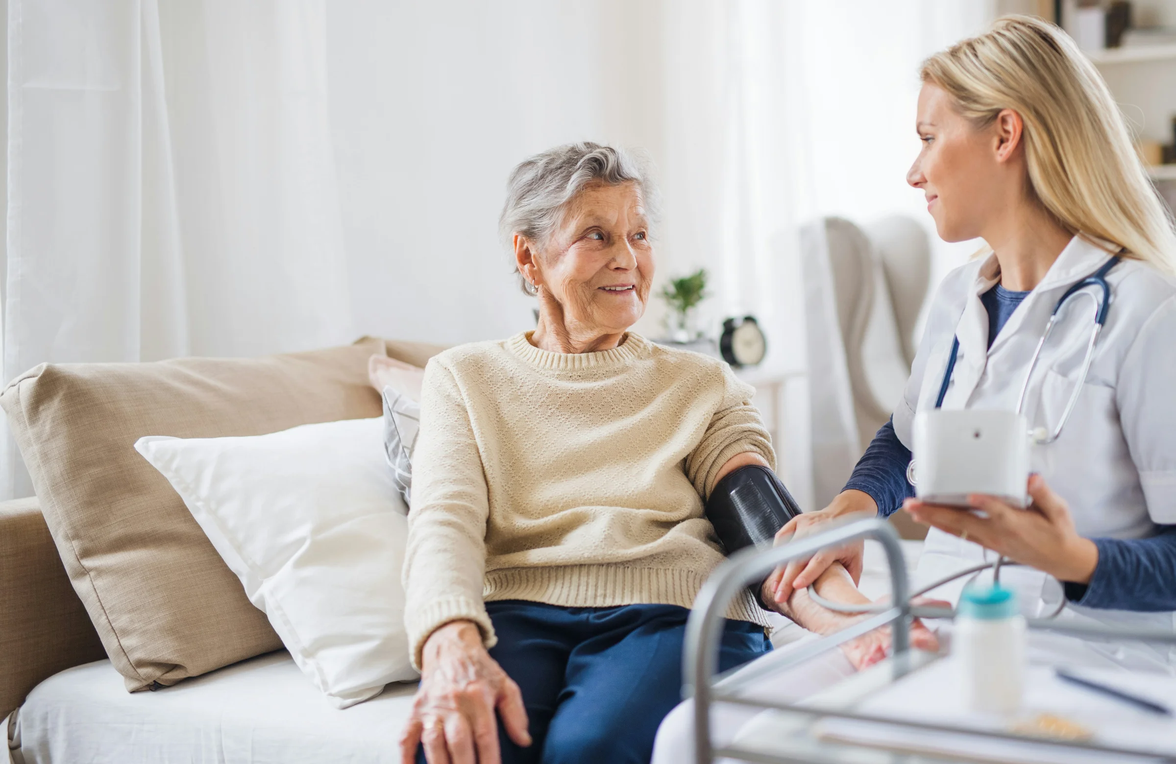 Community nurse discussing wound care with older client at home in Brisbane