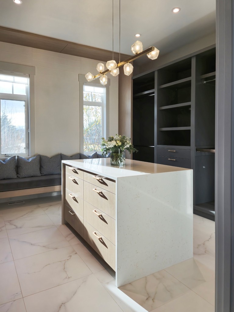 Image of Luxury primary suite with spacious walk-in closet and marble floors, designed by KHD Homes.