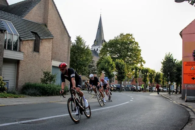 Cyclist riding past houses in a small village during an outdoor session