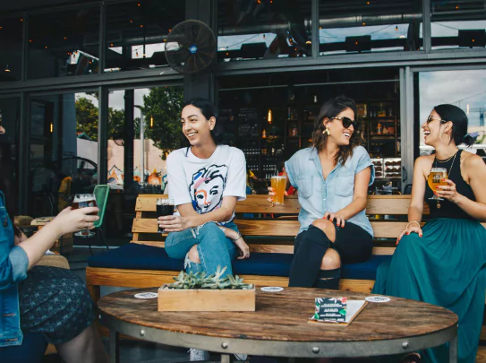 three women hanging out in a cafe