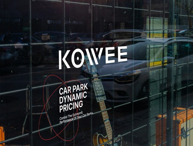 Kowee logo displayed on a storefront with the tagline ‘Car Park Dynamic Pricing,’ representing Kowee’s mission and solutions.