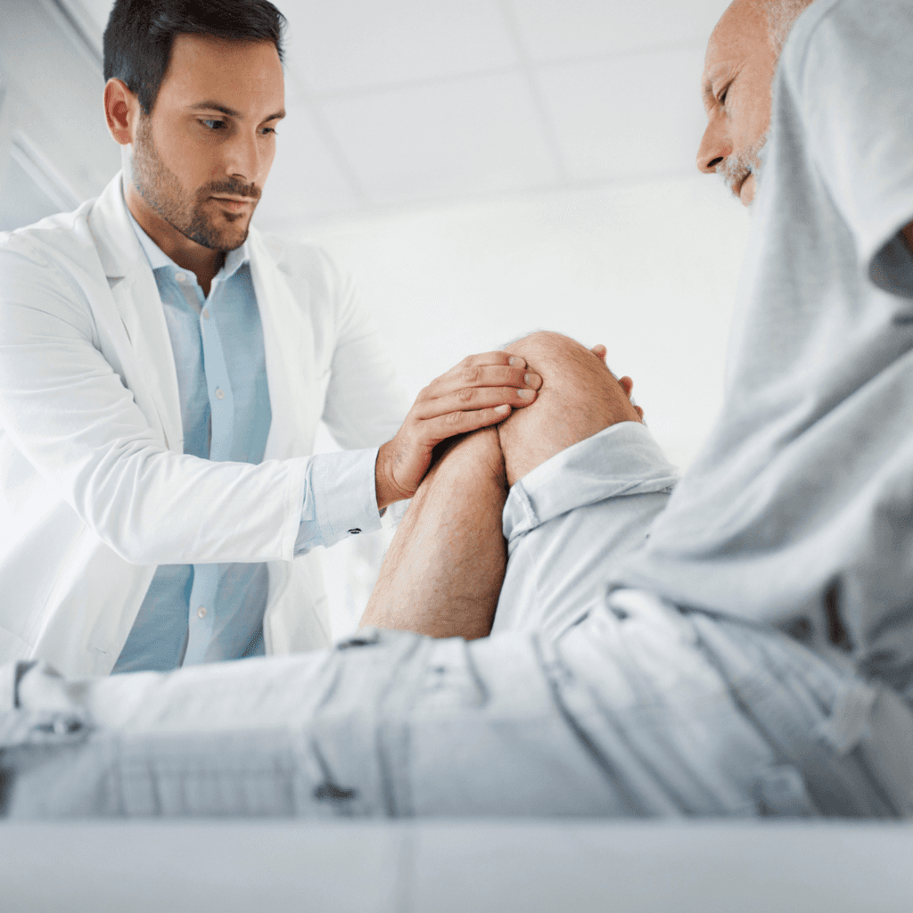 doctor examining knee injury