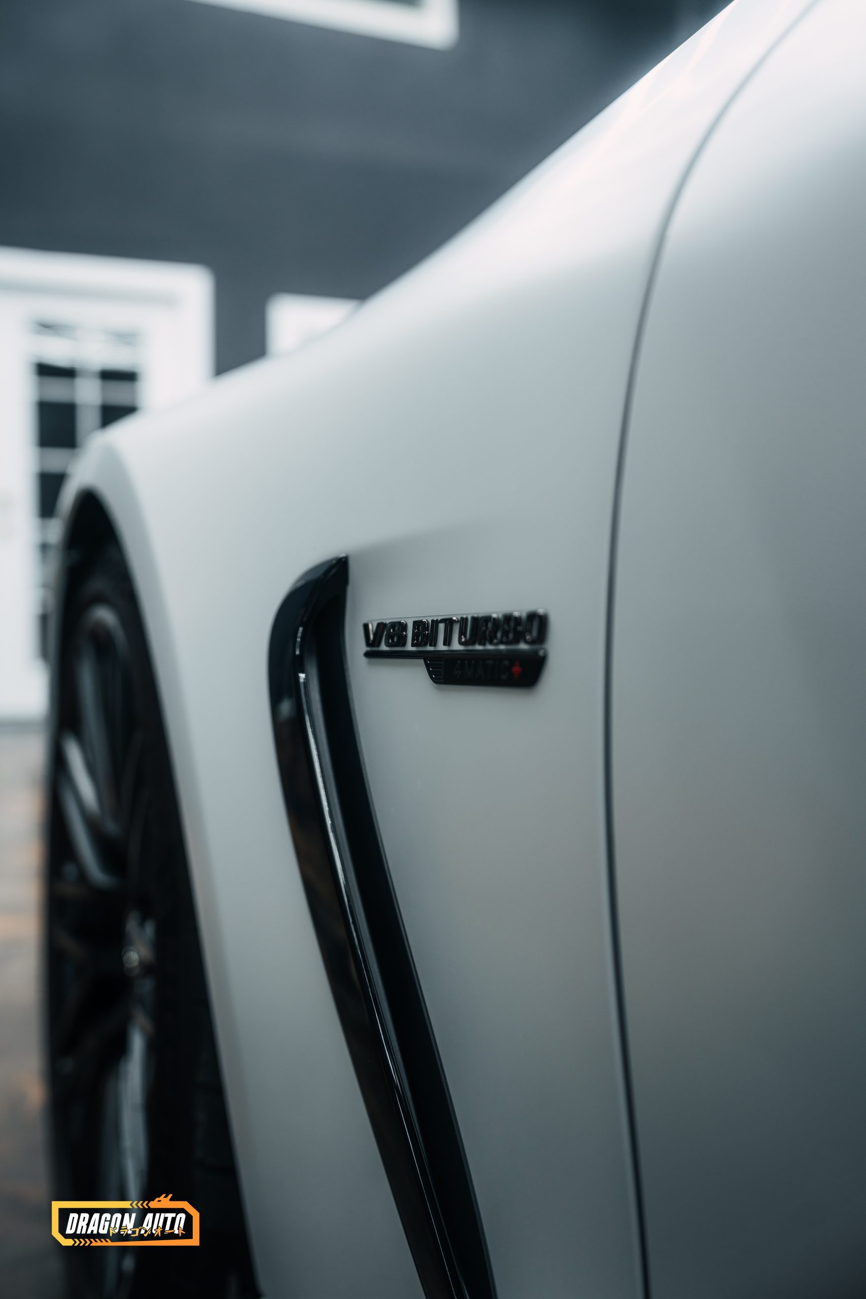 Matte white Mercedes AMG GT55, fender badge detail, at Dragon Auto in Milpitas