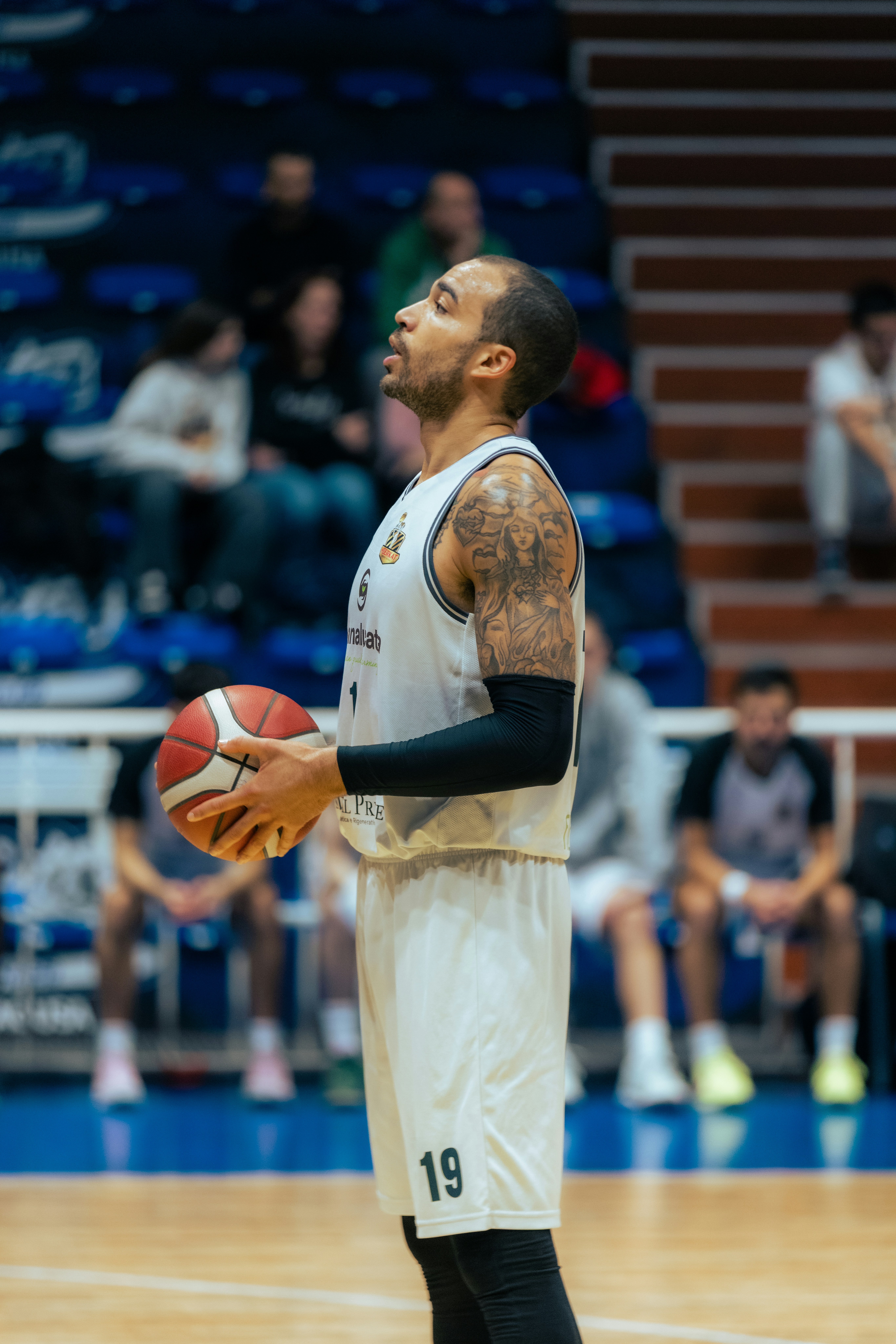 Basketball player holding ball on court