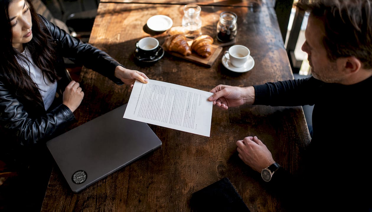 Hands exchanging beat license contract