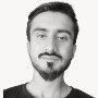 Grayscale portrait of a young man with a beard