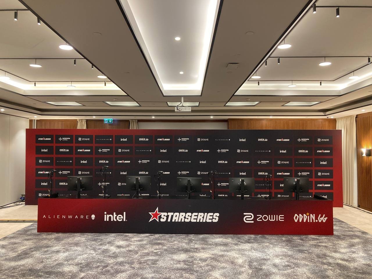 StarLadder CS2 Major Group Stage Budapest 2025 esports venue with sponsor backdrop, player desks and production setup