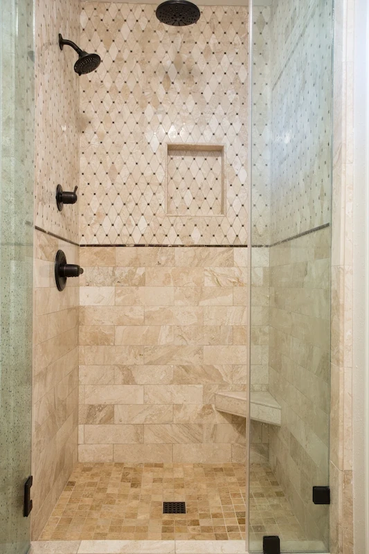 Custom shower with beige tiles, mosaic accent, and matte black fixtures in Orange Interior Remodel.