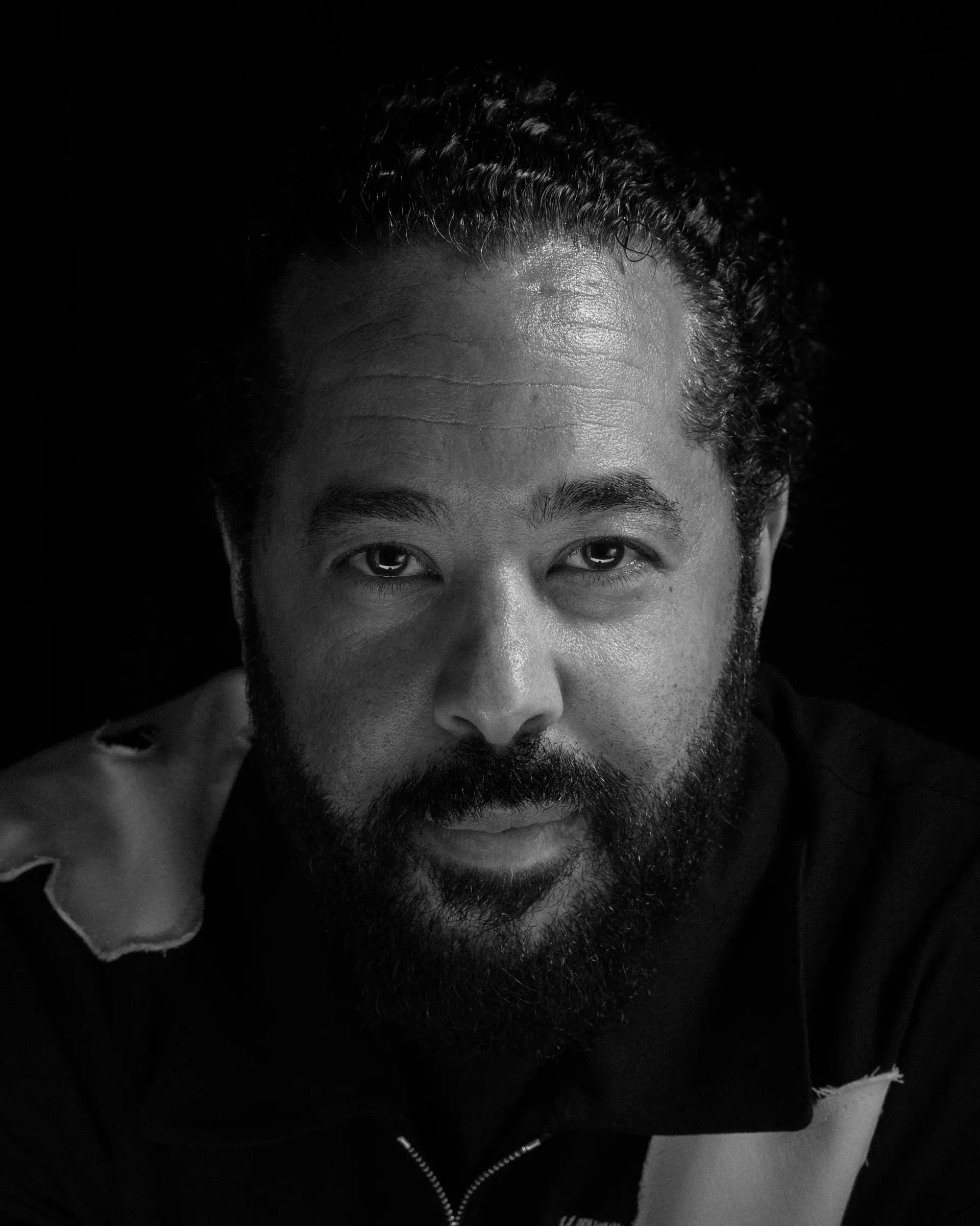 Intimate black and white editorial portrait of singer Adel Tawil looking directly at the camera.