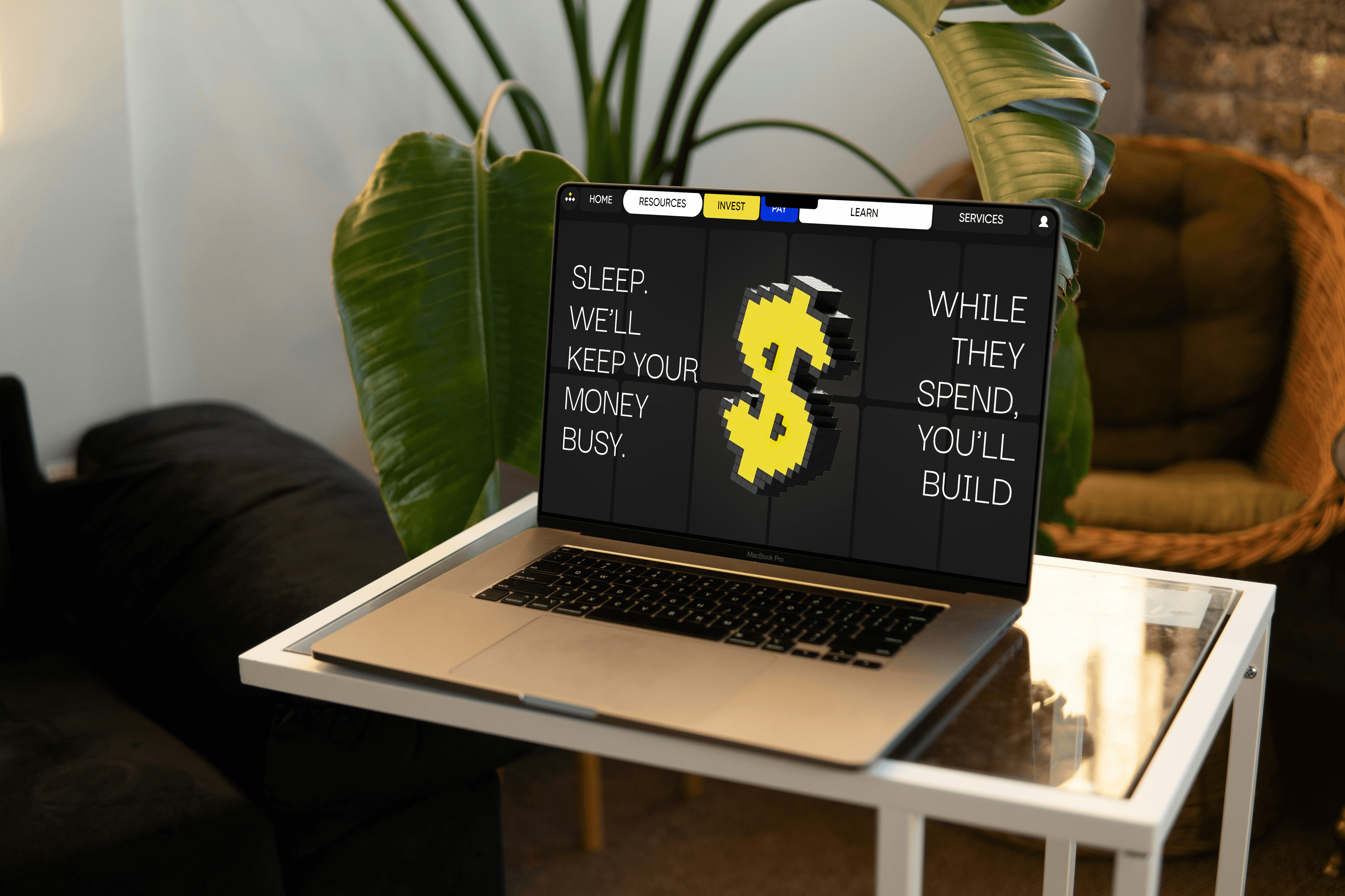 A sleek silver laptop sits on a white desk surrounded by lush green plants, displaying a website with a bold yellow dollar sign and motivational text, set in a cozy living room with soft lighting.