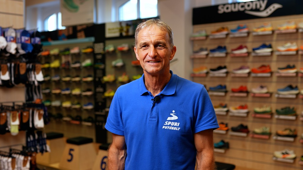man with shoes behind him in a display