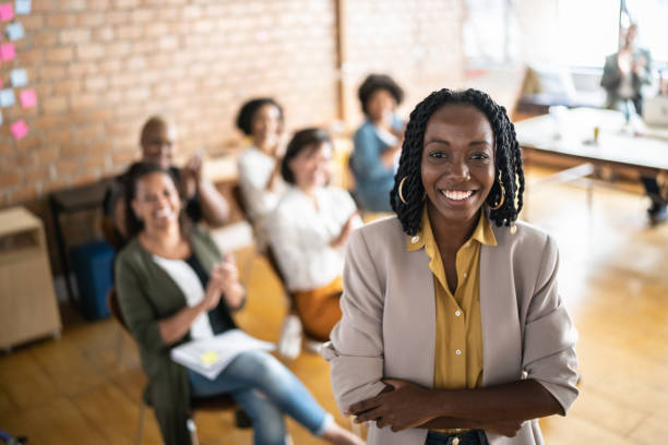 a lady smiling with a small group of people at her back