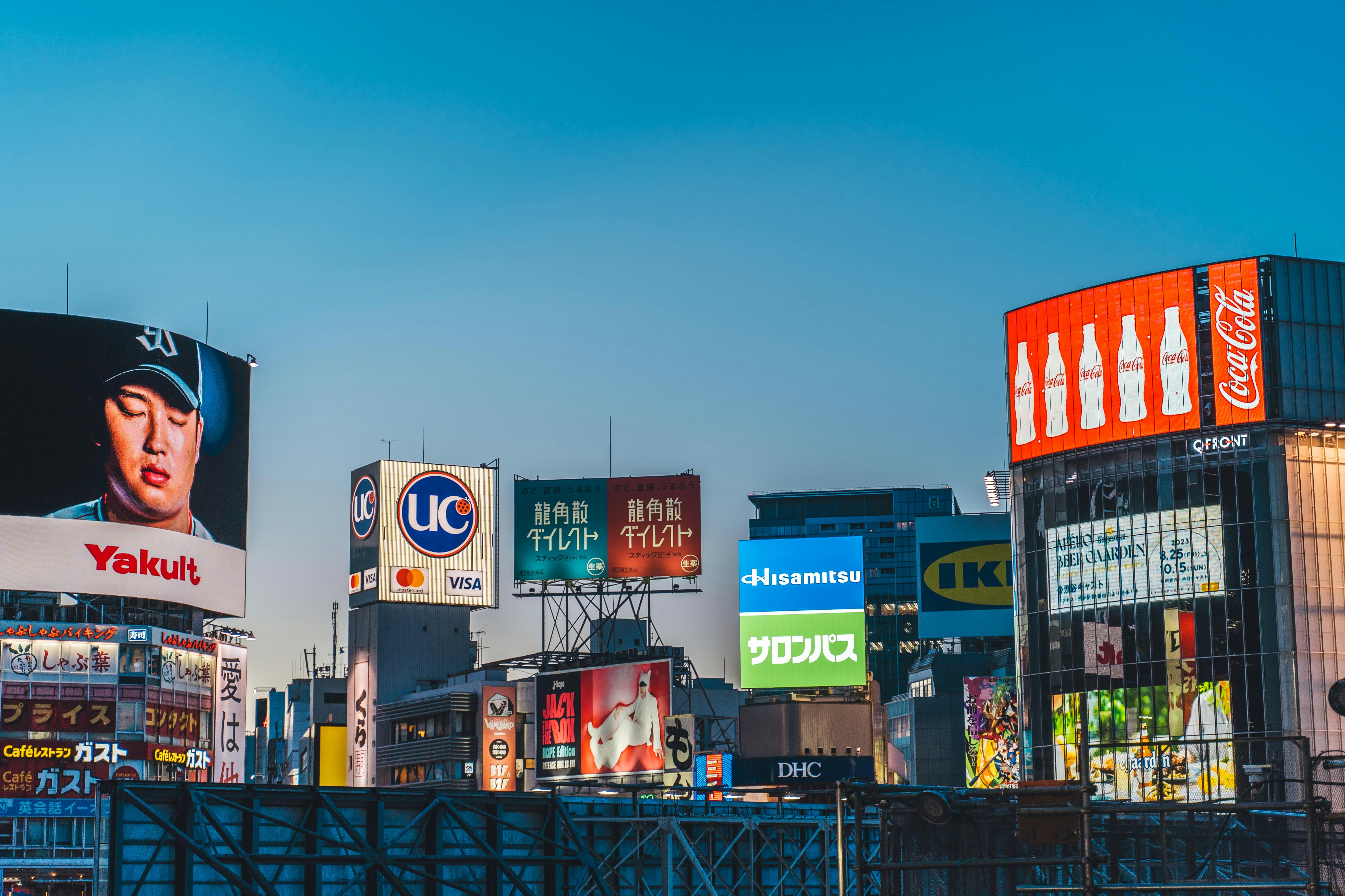 Bright city billboards displaying major global brands, symbolizing the future of digital and AI-driven advertising like upcoming ChatGPT ads