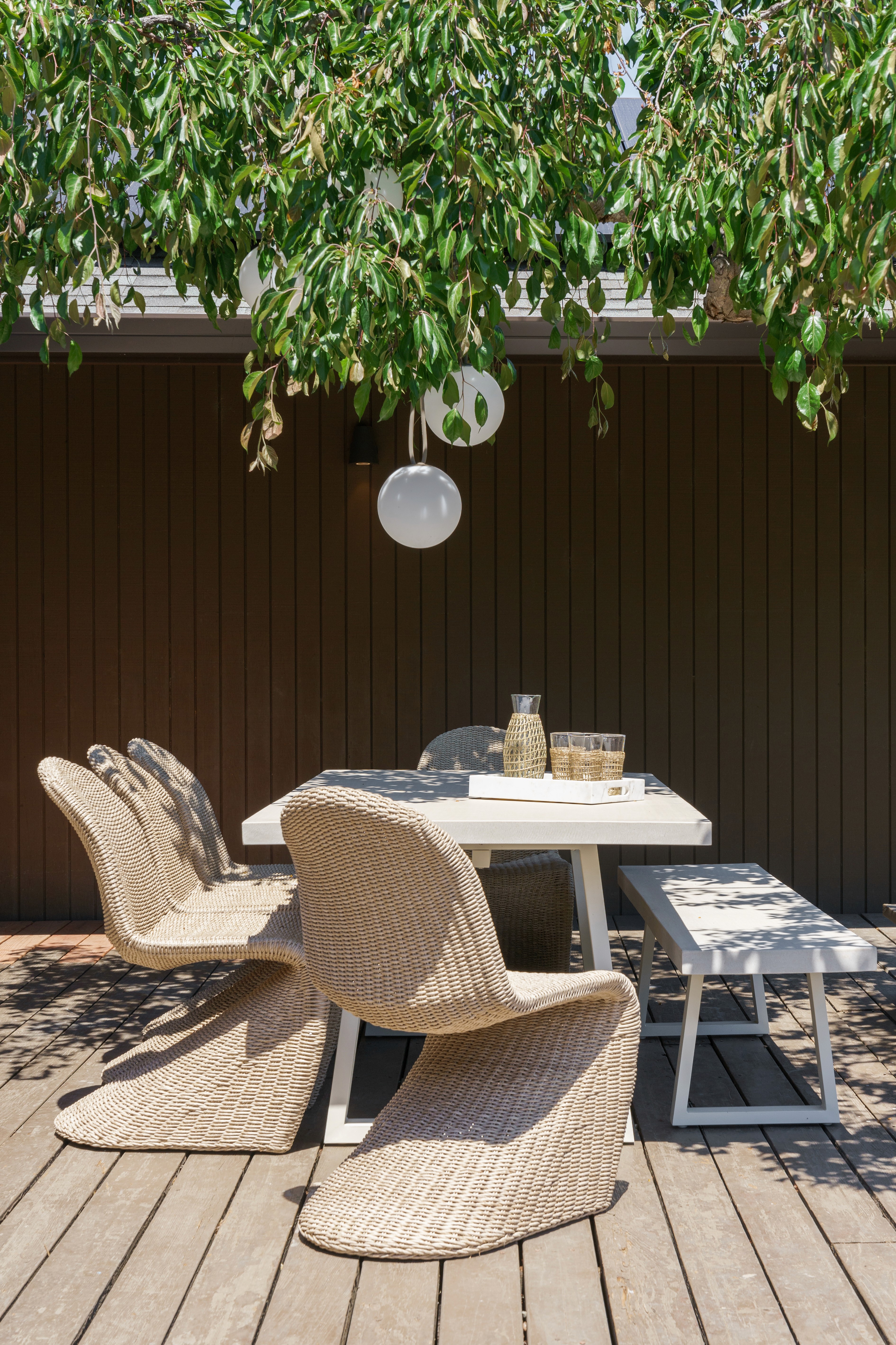 Outdoor pool-side  space design, raw wood tones, lush greenery