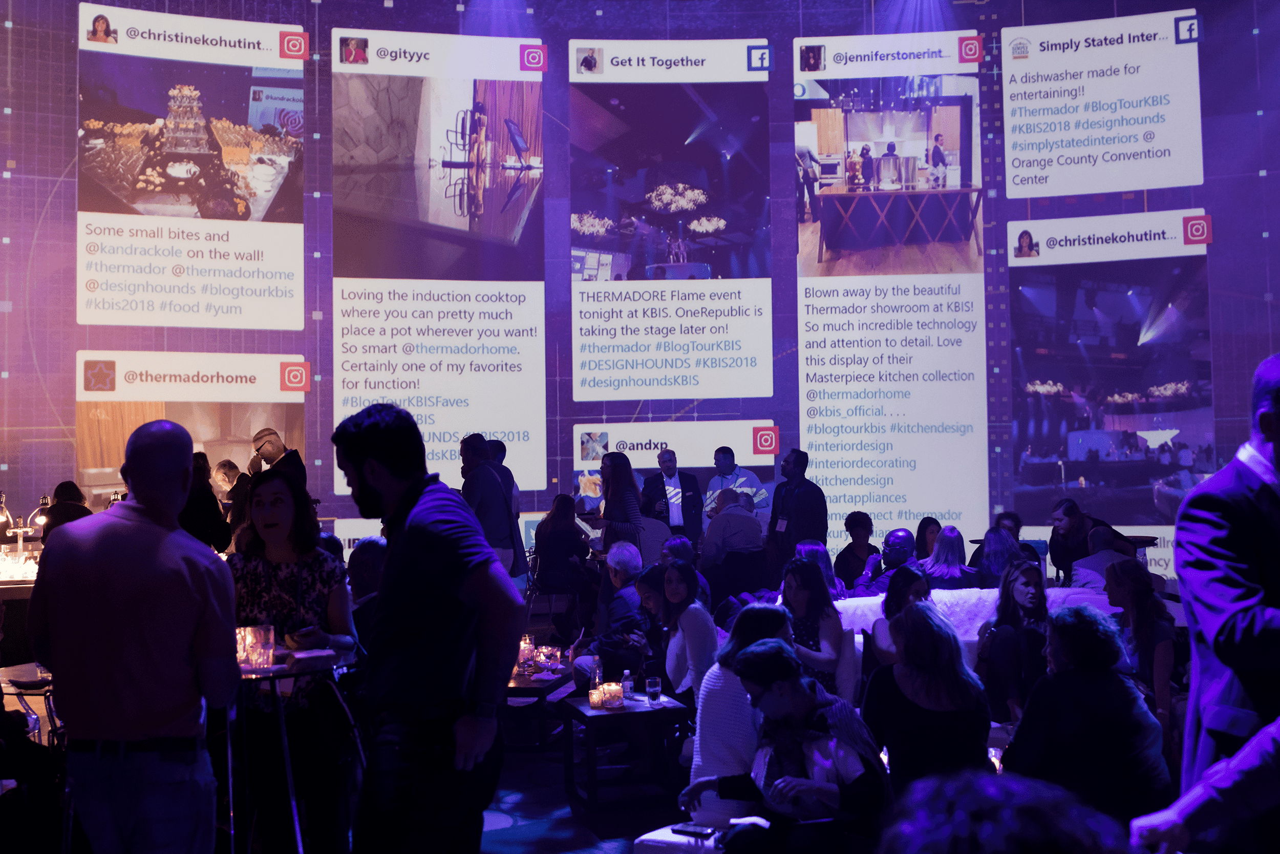 Thermador wall projecting solcial media feeds in the backdrop as silhouettes of attendees move about the room