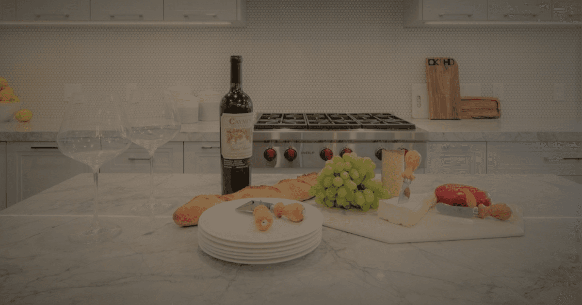 Image of Luxury kitchen interior design with marble island, wine, cheese board, and elegant furniture by KHD Homes.