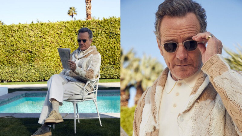Man in knitwear sits by a pool reading a newspaper in a polished lifestyle fashion editorial setting.
