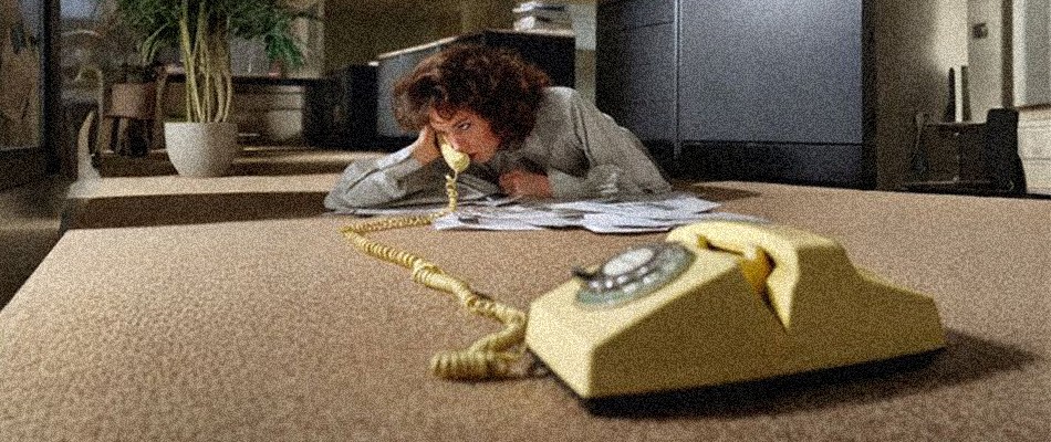 a man wearing a headset sitting in front of a computer