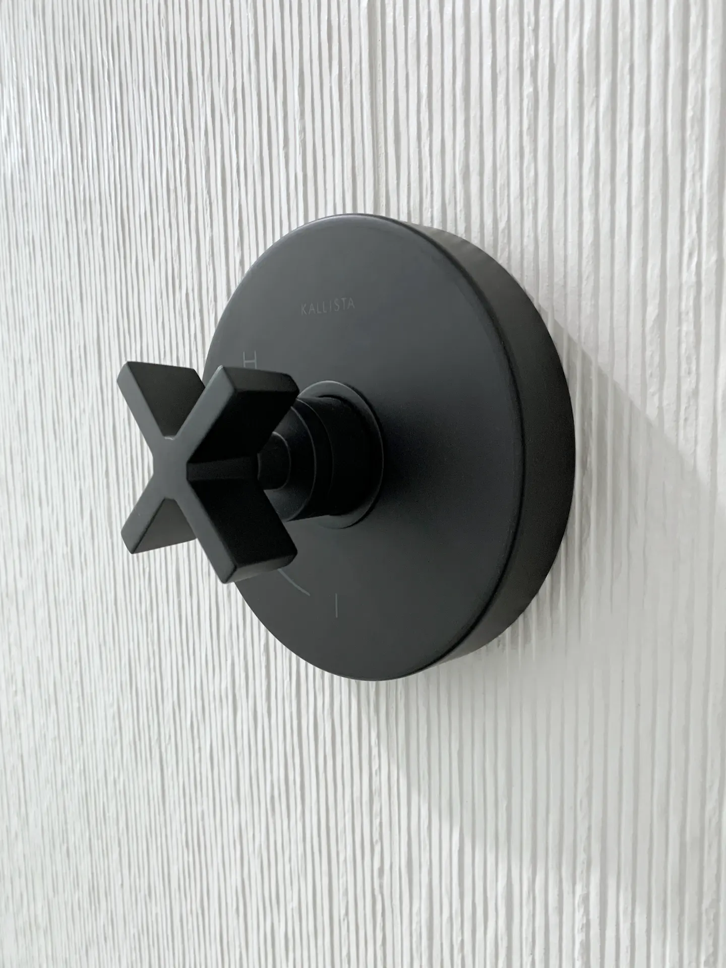 View of the shower valve in the guest bathroom, exemplifying the attention to detail in the bathroom's modern fixtures and overall design. Photo by Todd Huge.