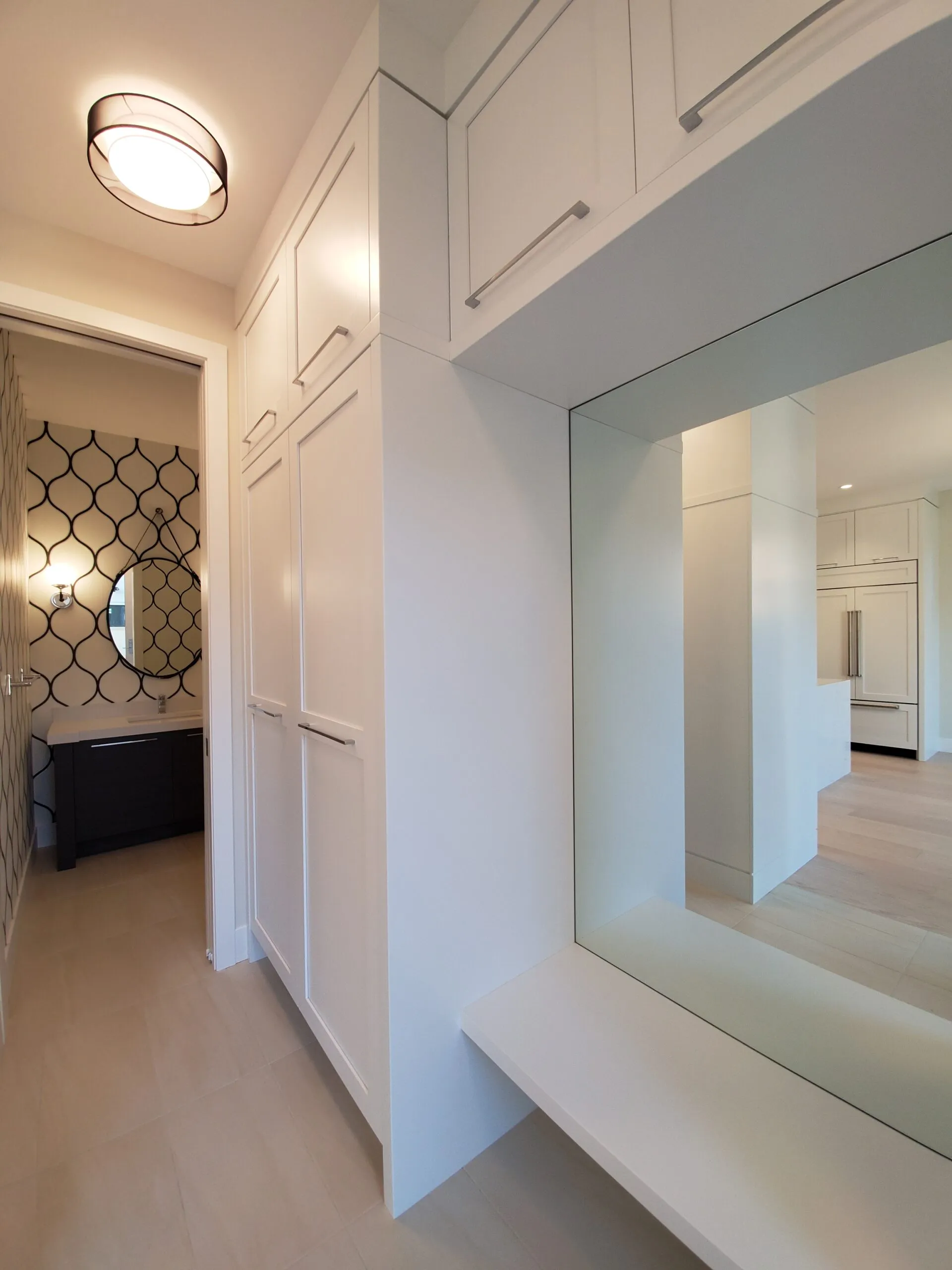 Image of white mudroom millwork and powder room.