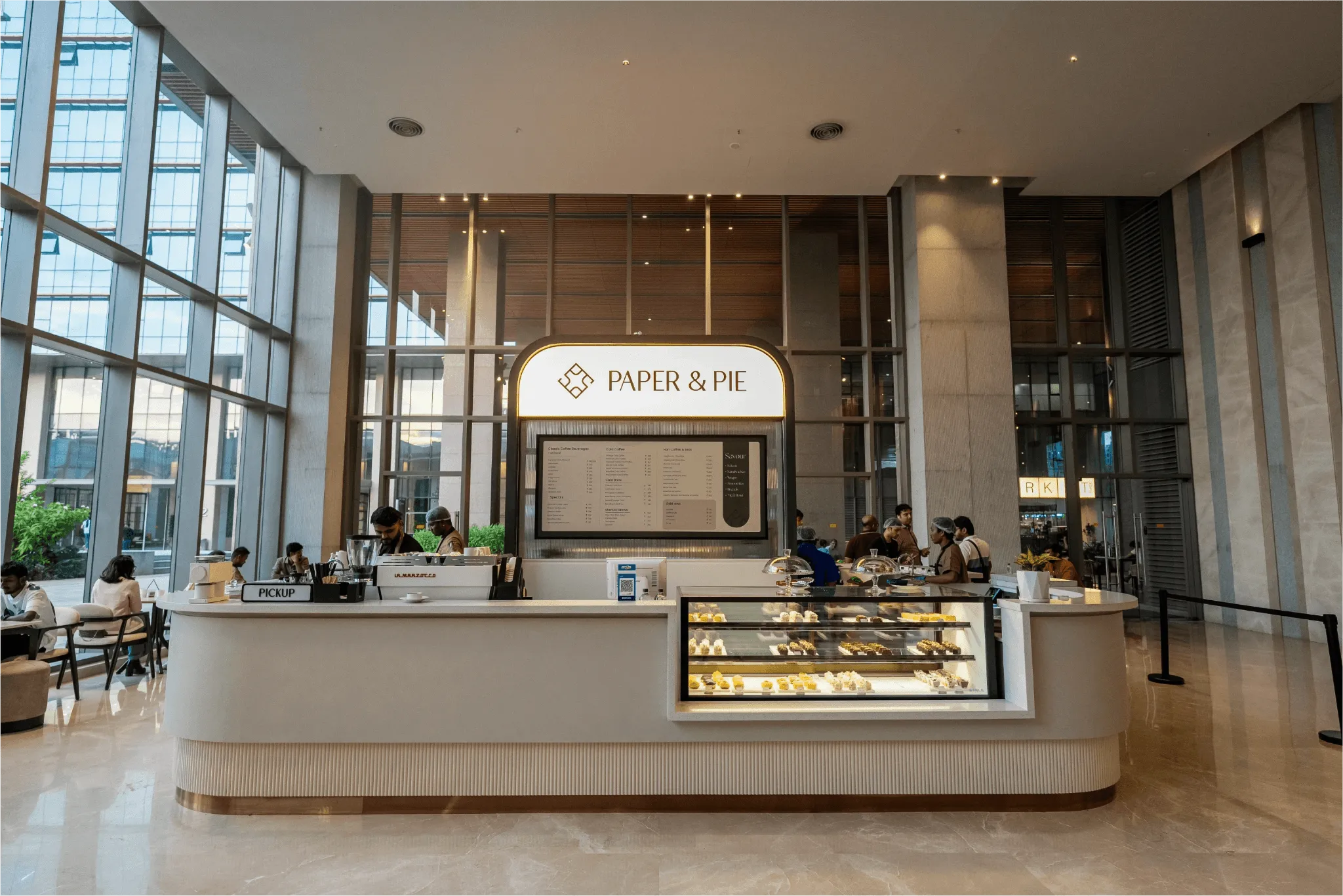 Minimalist interior of Paper & Pie cafe in Bangalore featuring warm lighting, creative seating, and cozy design — a vibrant hub for artists, freelancers, and thinkers.