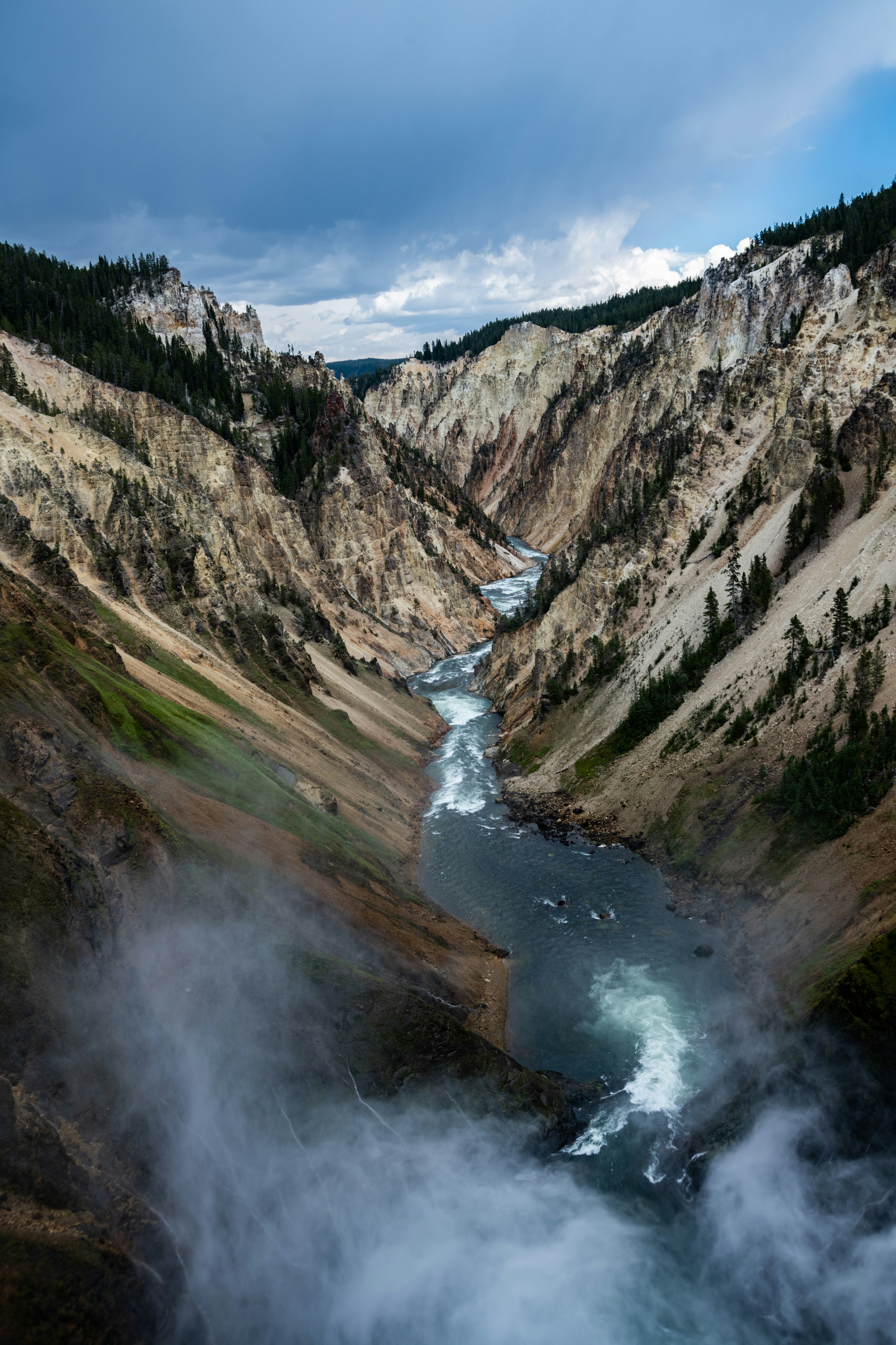 a river running through a valley surrounded by mountains
