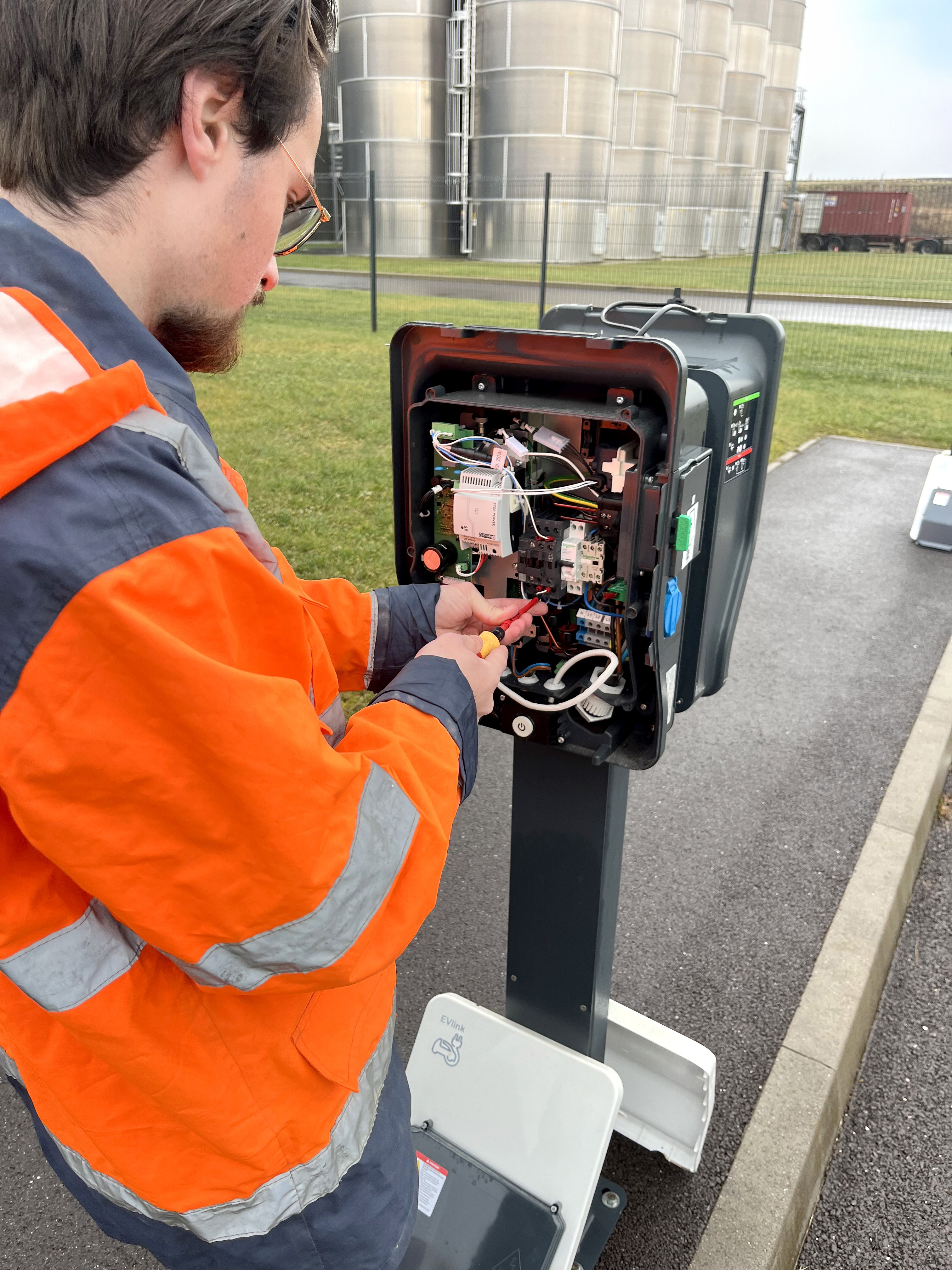 person holding green and black circuit board