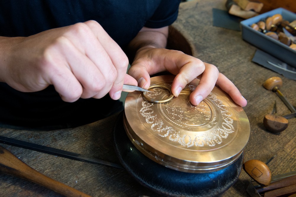 brown and white concrete house near green trees during daytime
