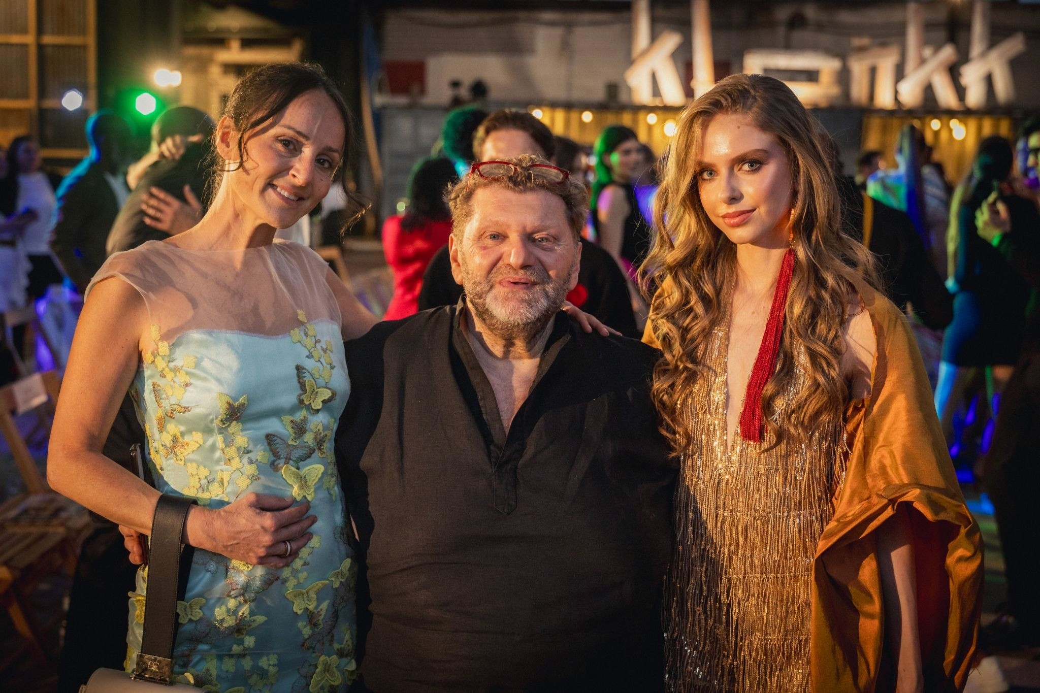 Nelly Opitz stands with Sonia Salvati and Pietro Paradiso at a fashion event.