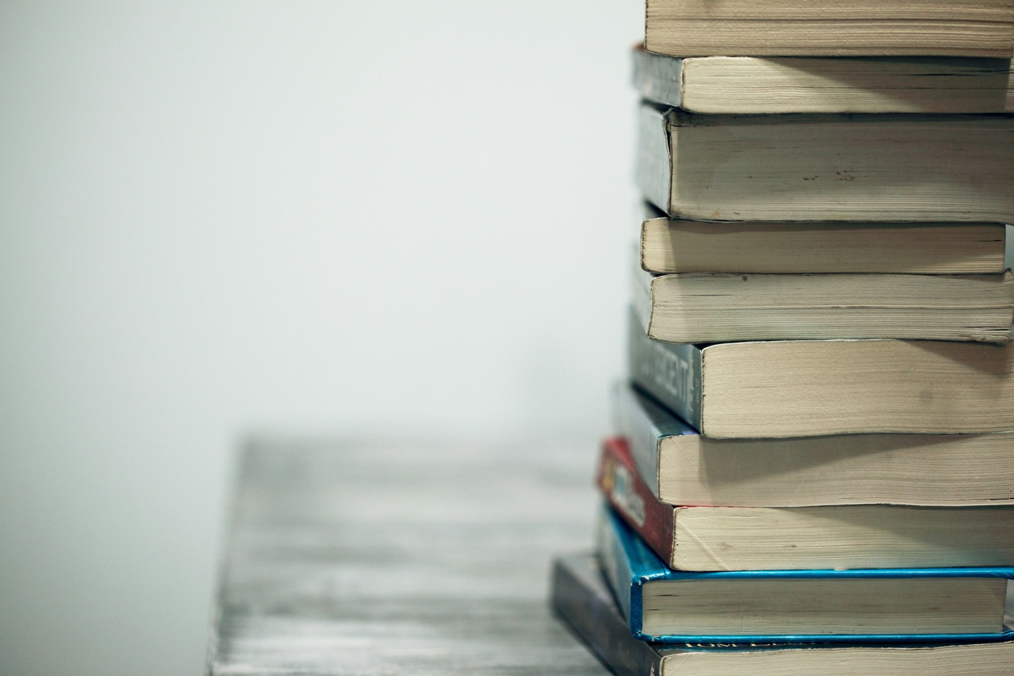 A stack of worn paperback books.