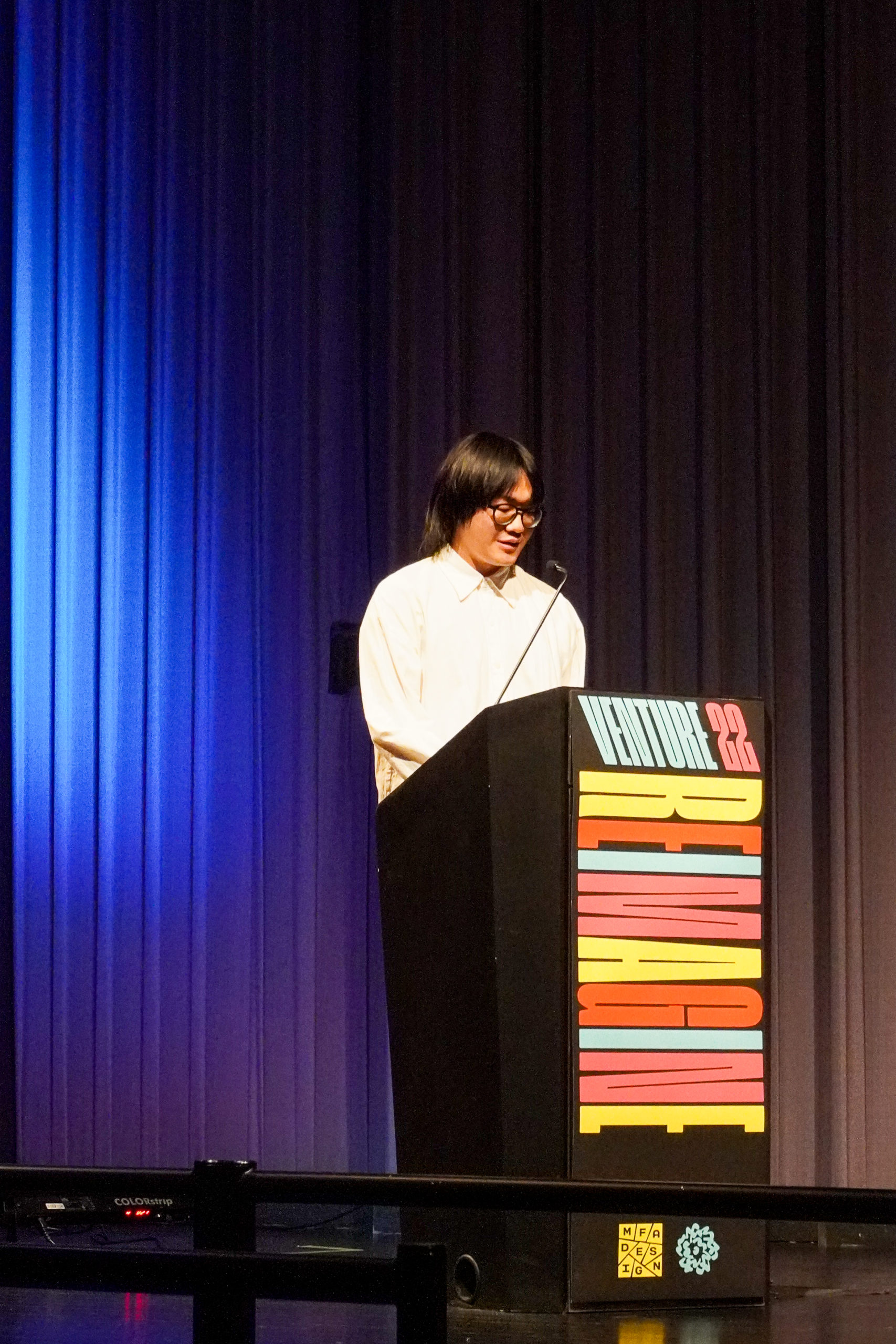 student presenting at podium for Venture Forum 22