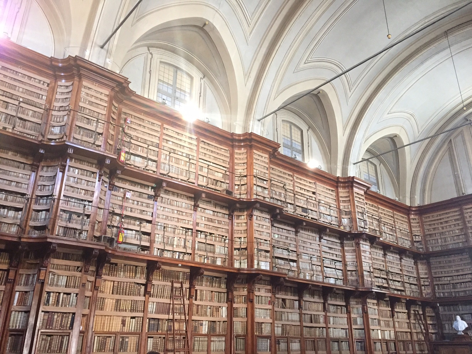 A multi story library in a churchlike building.