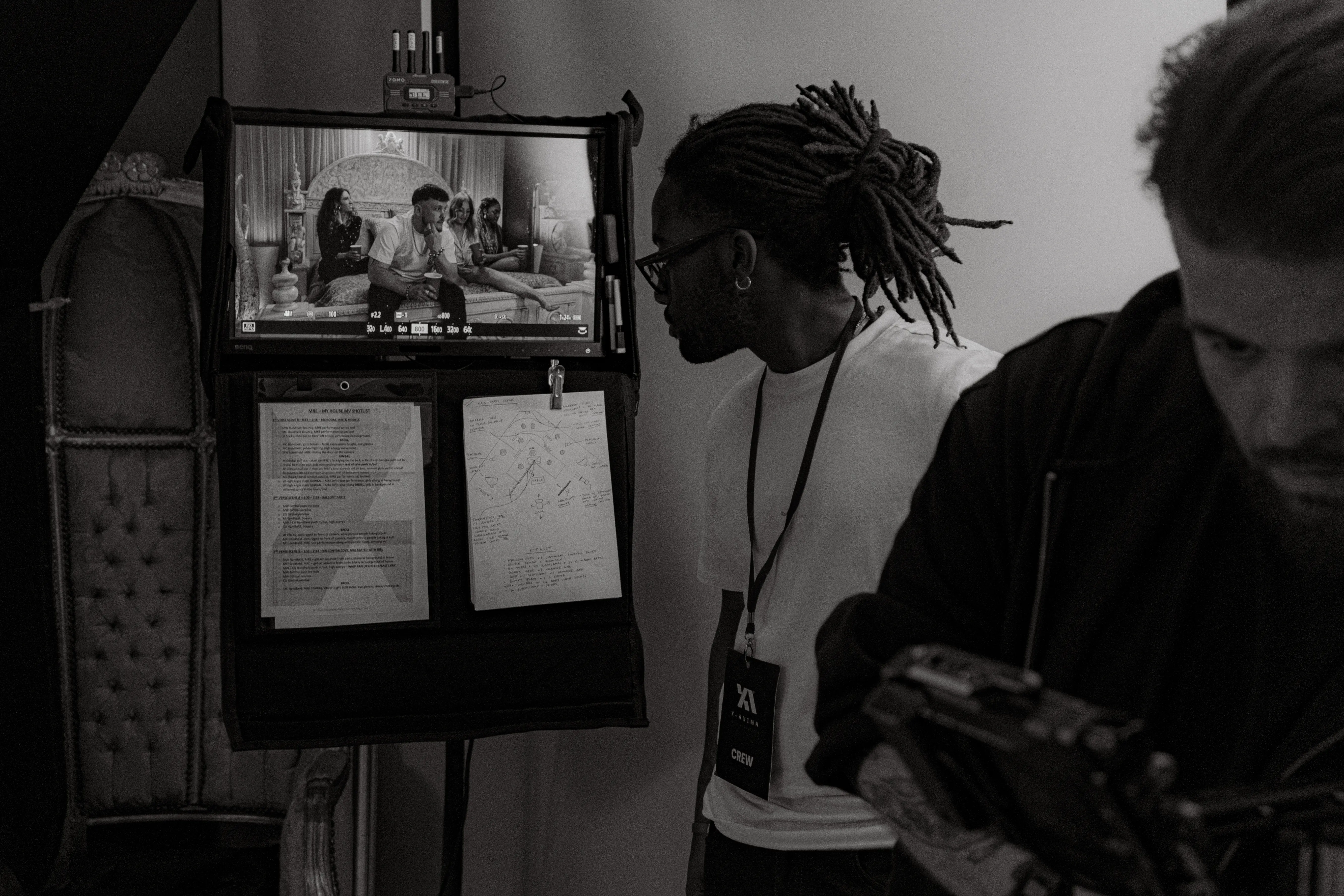 Behind the scenes of a London creative studio with a producer checking music video playback