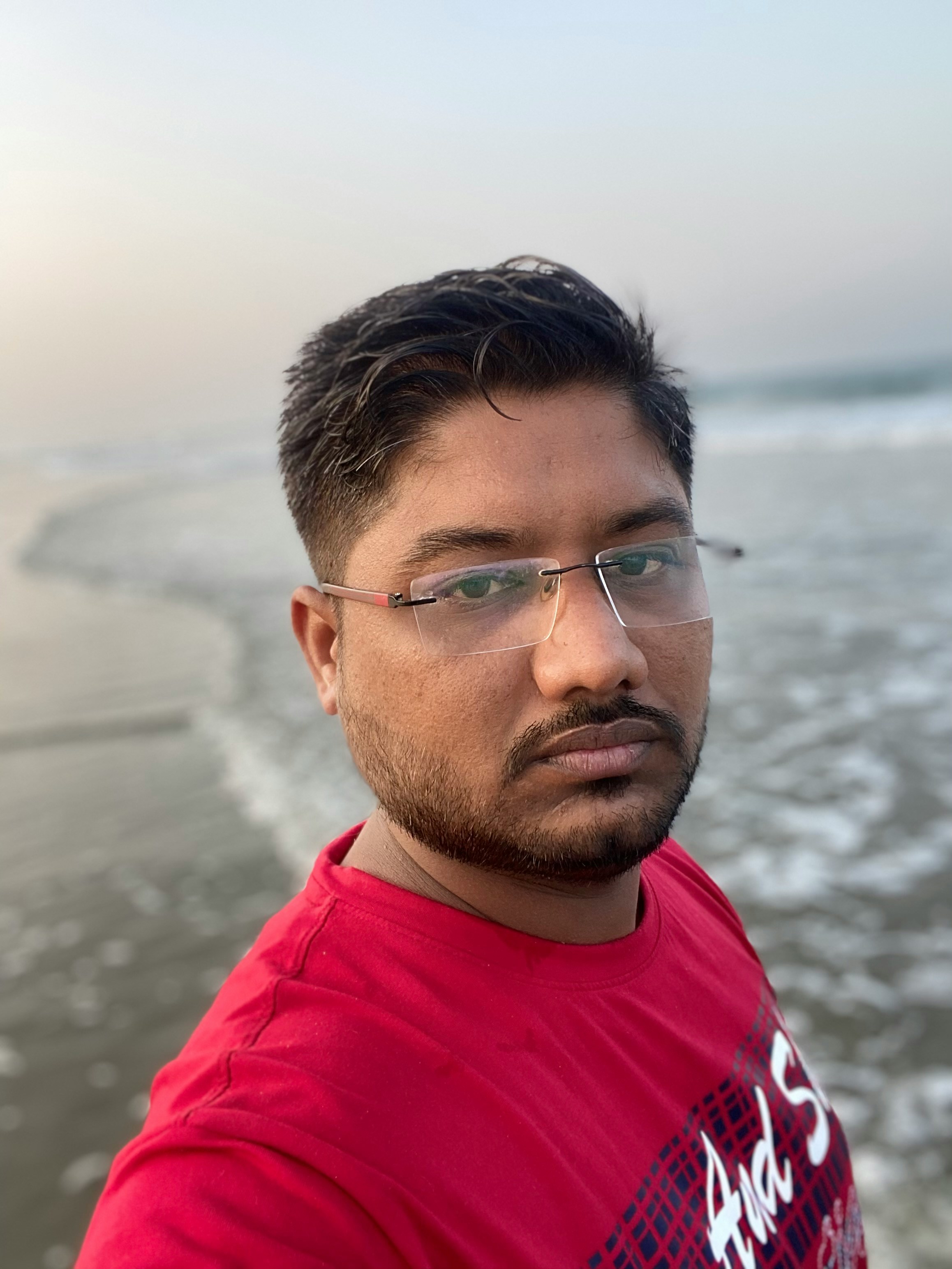 man in red crew neck shirt wearing eyeglasses