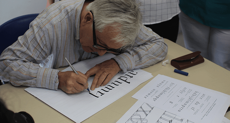 men doing calligraphy